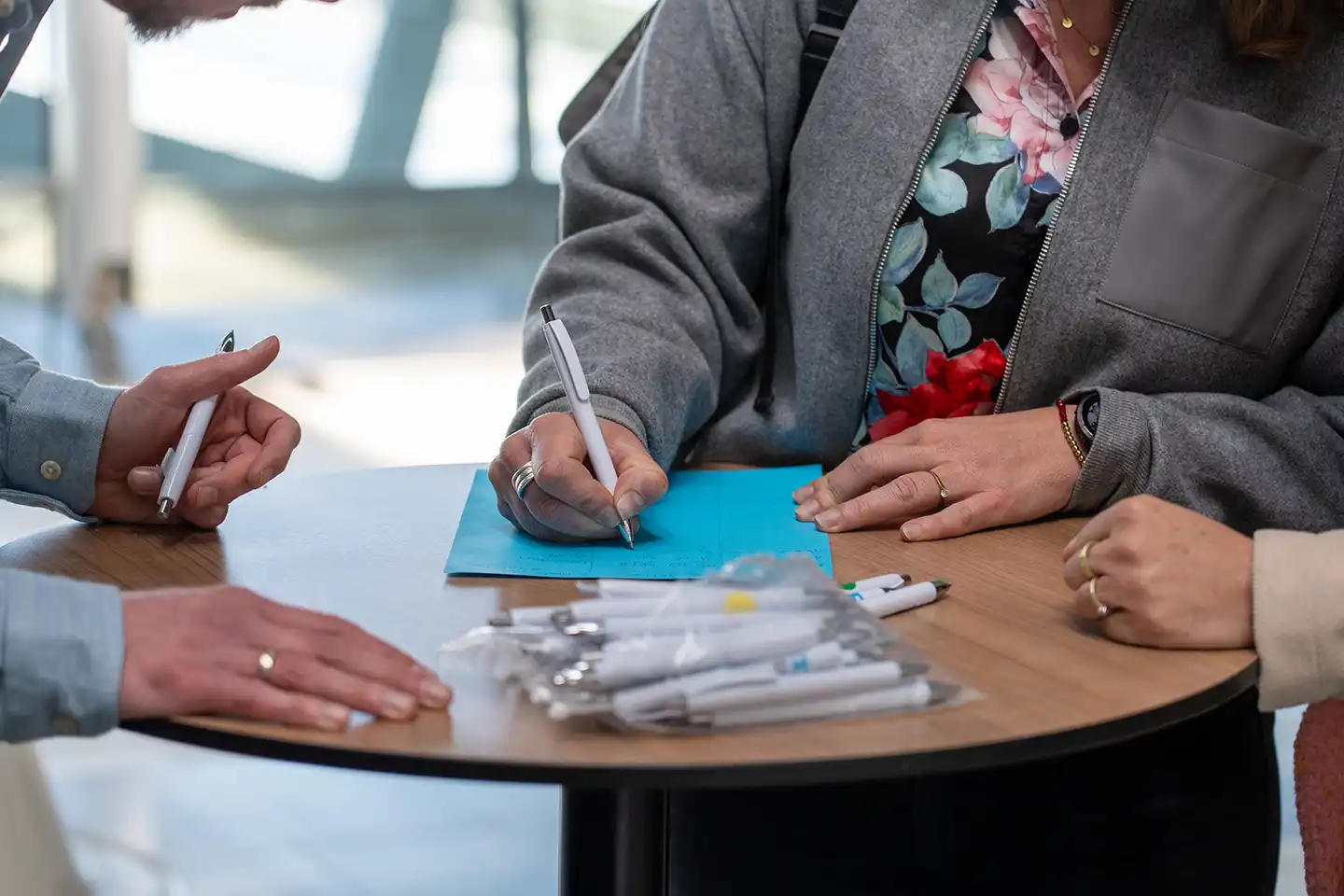 Deelnemer vult een kaartje in aan een statafel tijdens de bijeenkomst, fotografie bij de promotiefilm van Humanitas DMH